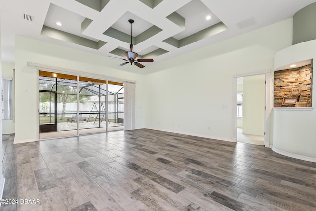 interior space featuring hardwood / wood-style flooring, ceiling fan, a high ceiling, and coffered ceiling