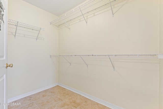 spacious closet featuring light tile patterned flooring