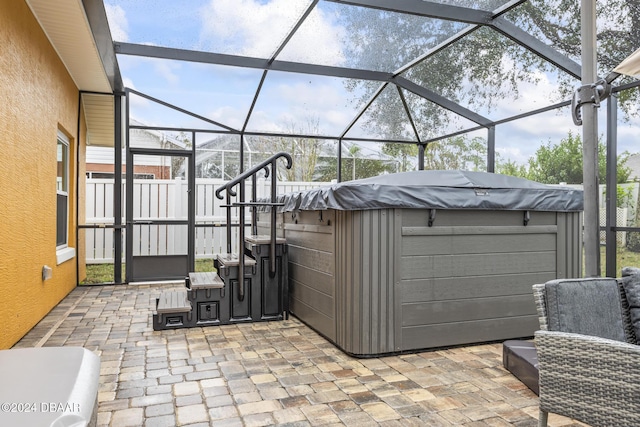 view of patio featuring a lanai and a hot tub