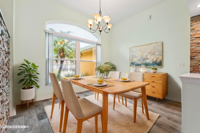 dining room featuring hardwood / wood-style flooring and an inviting chandelier