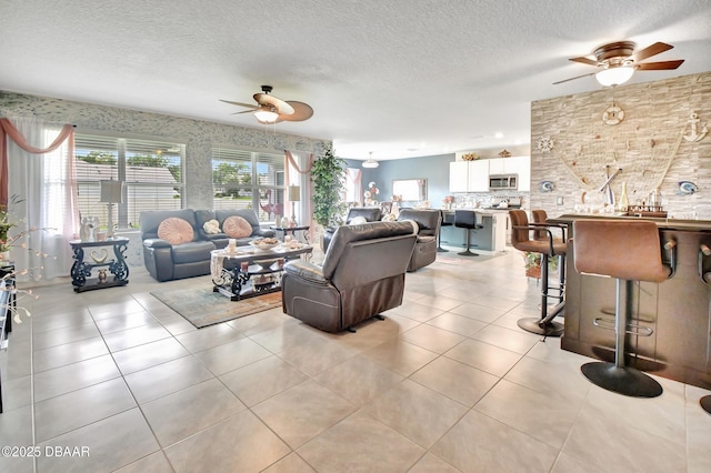 316 Nowell Loop, Deland, FL 32724 - living area featuring ceiling fan, healthy amount of natural light, a textured ceiling, and light tile patterned floors