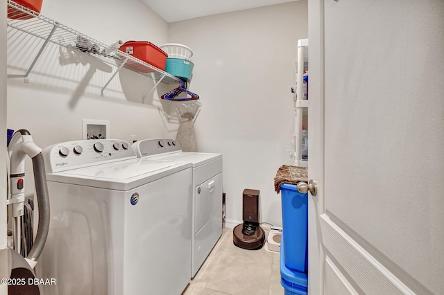 316 Nowell Loop, Deland, FL 32724 - laundry area featuring washing machine and dryer, light tile patterned flooring, and baseboards