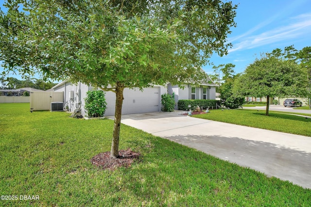316 Nowell Loop, Deland, FL 32724 - view of property hidden behind natural elements featuring driveway, a front lawn, cooling unit, an attached garage, and stucco siding