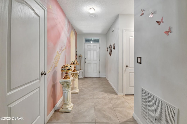 316 Nowell Loop, Deland, FL 32724 - hallway with baseboards, a textured ceiling, and light tile patterned floors