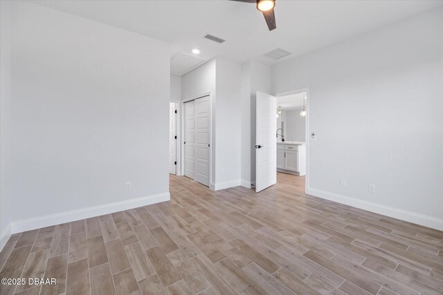 45 Fenhill Ln, Palm Coast, FL 32137 - unfurnished bedroom with light wood-style floors, baseboards, recessed lighting, ceiling fan, and a sink