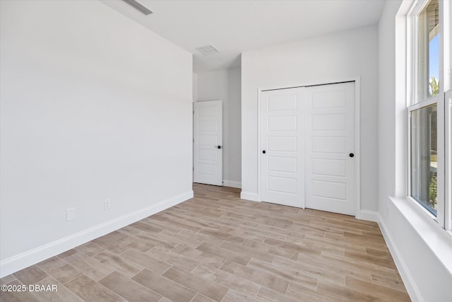 45 Fenhill Ln, Palm Coast, FL 32137 - unfurnished bedroom featuring light wood-type flooring, baseboards, and a closet