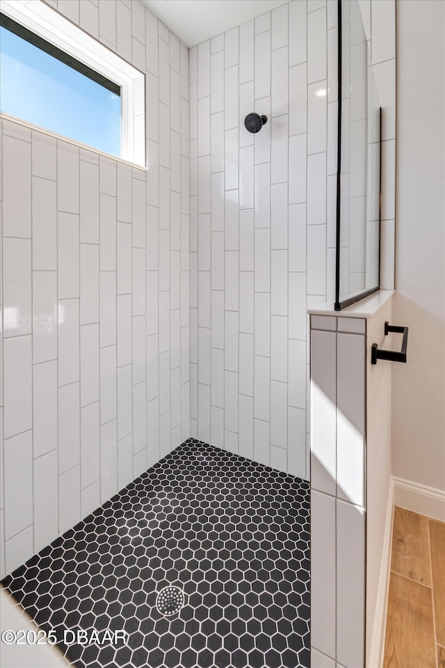 45 Fenhill Ln, Palm Coast, FL 32137 - full bath with a tile shower, wood finished floors, and baseboards