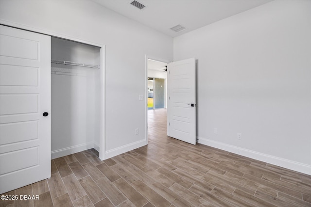 45 Fenhill Ln, Palm Coast, FL 32137 - unfurnished bedroom featuring wood finished floors, baseboards, and a closet