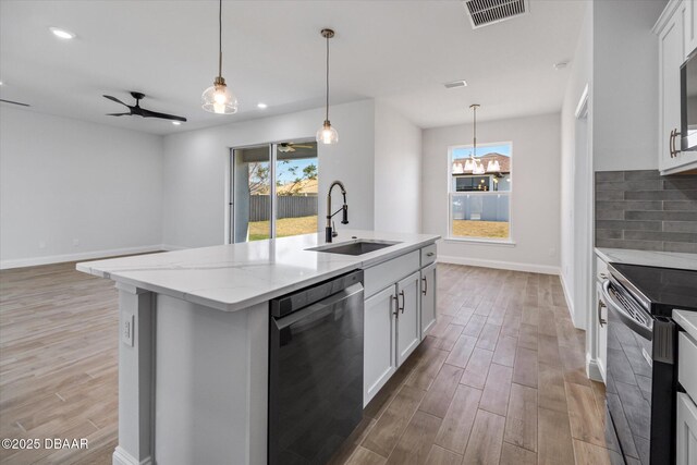 45 Fenhill Ln, Palm Coast, FL 32137 - kitchen featuring dishwasher, a sink, black range with electric cooktop, light wood-style flooring, and recessed lighting