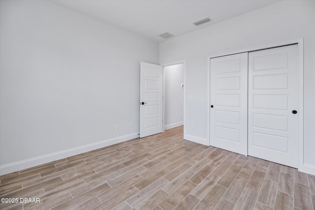45 Fenhill Ln, Palm Coast, FL 32137 - unfurnished bedroom with light wood-style floors, baseboards, and a closet