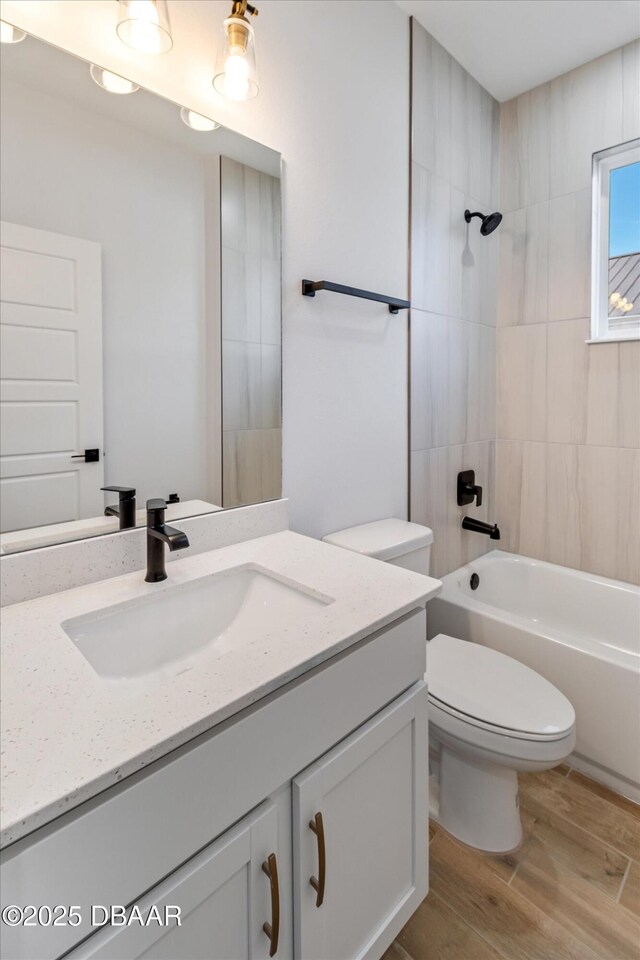 45 Fenhill Ln, Palm Coast, FL 32137 - bathroom with toilet, wood finished floors, bathtub / shower combination, and vanity