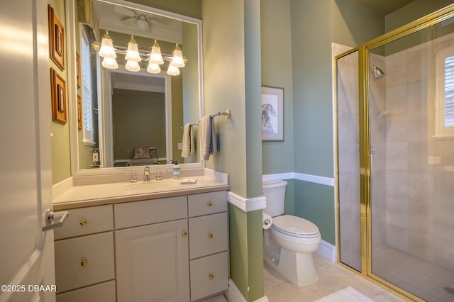 bathroom featuring toilet, tile patterned floors, a shower stall, and vanity