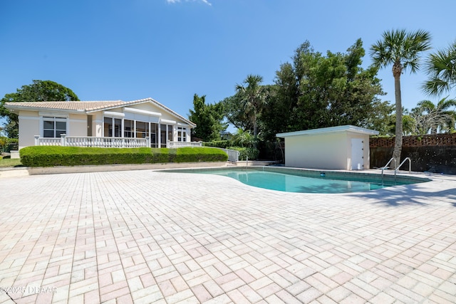 pool with fence and a patio area