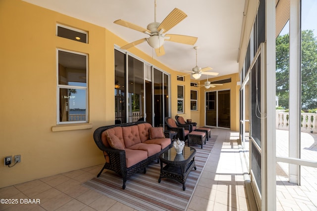 sunroom / solarium featuring an outdoor hangout area, ceiling fan, and a wealth of natural light