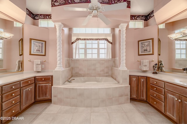 full bath with tile patterned floors, decorative columns, ceiling fan, and a garden tub
