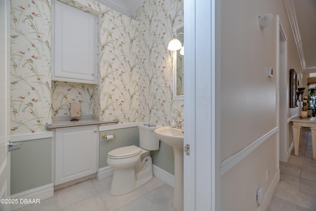 bathroom with toilet, tile patterned flooring, wallpapered walls, and baseboards