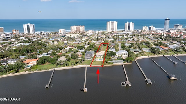 birds eye view of property with a city view and a water view