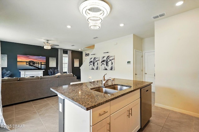 3049 Meleto Blvd, New Smyrna Beach, FL 32168 - kitchen with a sink, dishwasher, light tile patterned floors, ceiling fan, and dark stone counters