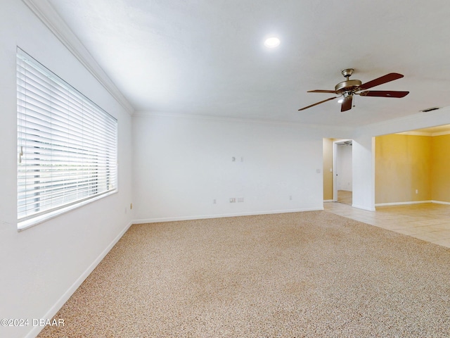 carpeted spare room featuring ceiling fan and ornamental molding