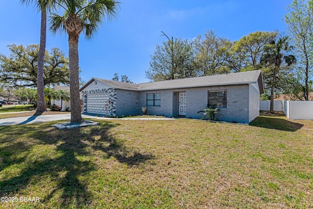 view of front of property with brick siding, fence, a front yard, a garage, and driveway