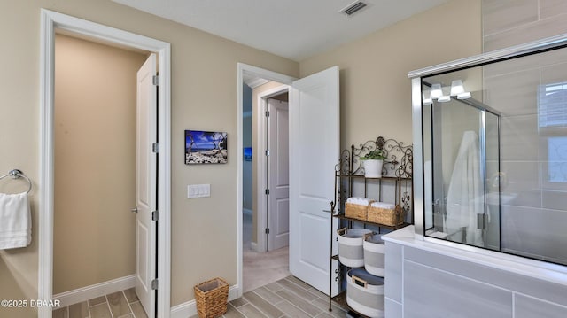4119 Clifden Dr, Ormond Beach, FL 32174 - full bath with a stall shower, baseboards, and wood tiled floors