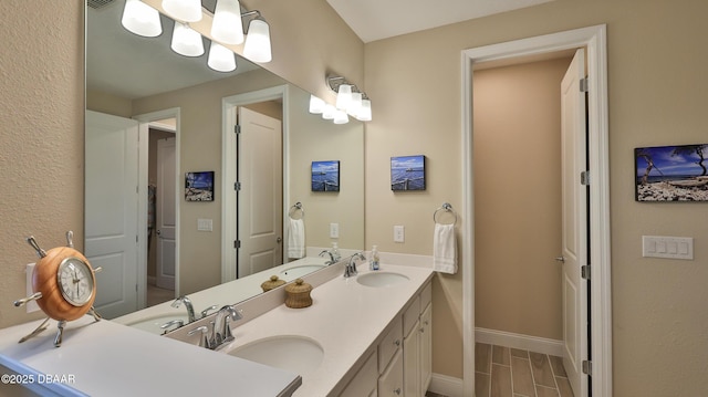 4119 Clifden Dr, Ormond Beach, FL 32174 - bathroom featuring double vanity and baseboards