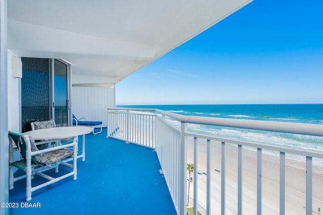 balcony featuring a water view and a view of the beach