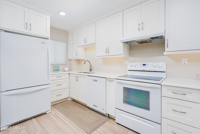 kitchen featuring white cabinetry, sink, and white appliances