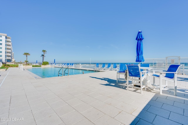 view of pool with a water view