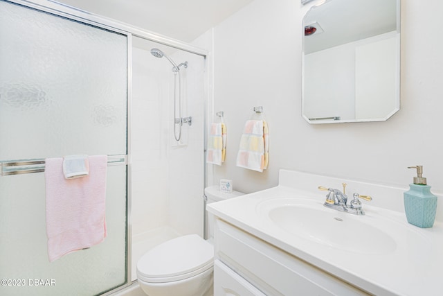 bathroom featuring vanity, toilet, and walk in shower