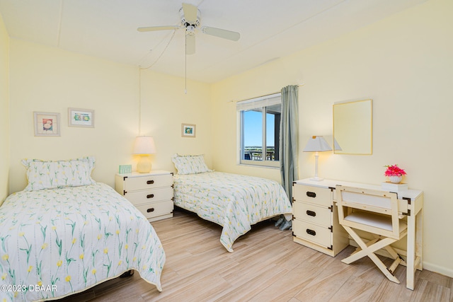 bedroom with ceiling fan and light hardwood / wood-style flooring