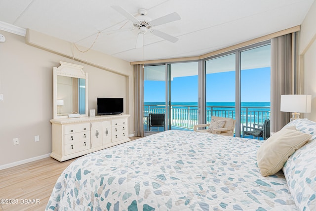 bedroom with ceiling fan, expansive windows, access to exterior, and light hardwood / wood-style flooring