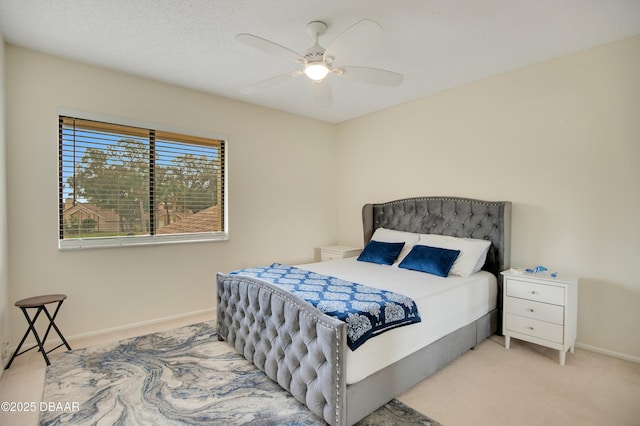 bedroom with ceiling fan and light colored carpet