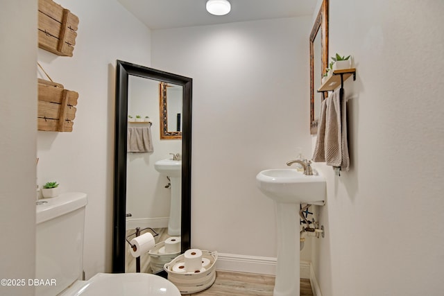 bathroom with toilet and hardwood / wood-style flooring