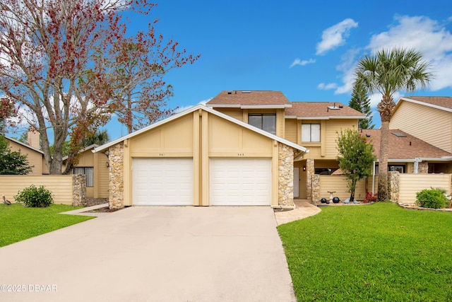 view of front of property featuring a front yard and a garage