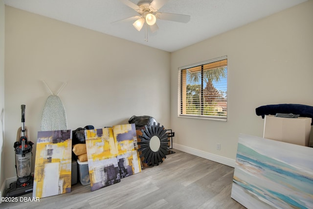 miscellaneous room with ceiling fan and wood-type flooring