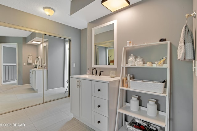 bathroom with tile patterned floors and vanity