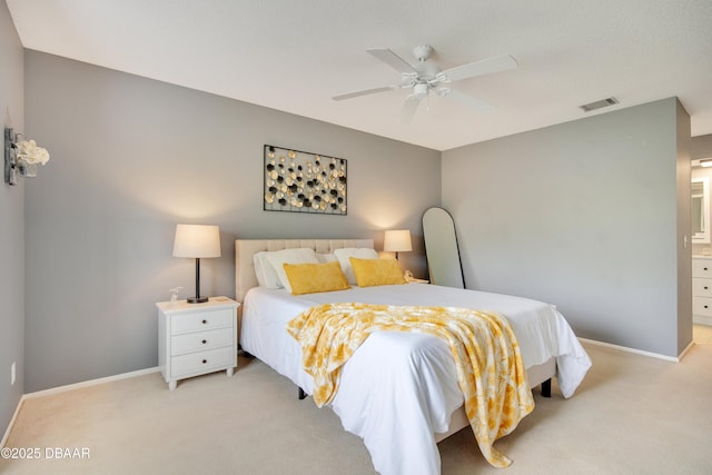 carpeted bedroom featuring ceiling fan and ensuite bathroom