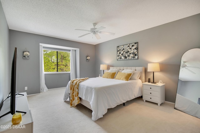 carpeted bedroom featuring a textured ceiling and ceiling fan