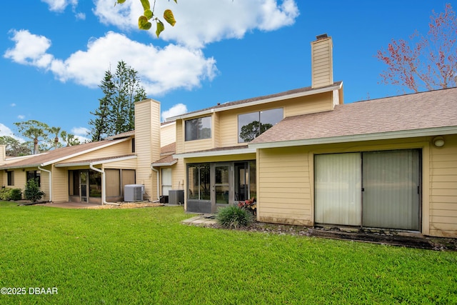 back of property featuring a lawn, central AC unit, and a patio area