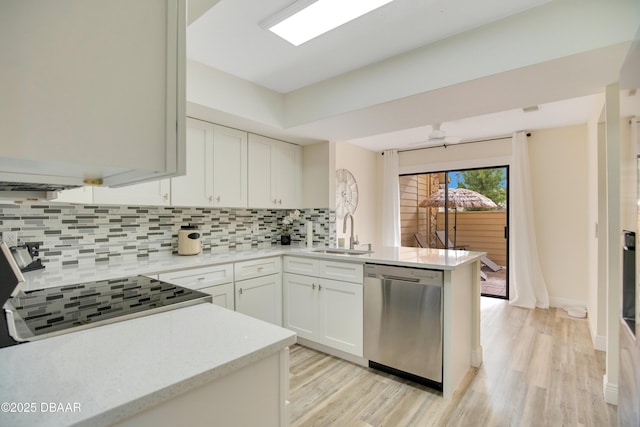 kitchen with dishwasher, kitchen peninsula, decorative backsplash, sink, and white cabinets