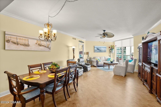 dining area with ceiling fan with notable chandelier, a textured ceiling, and ornamental molding