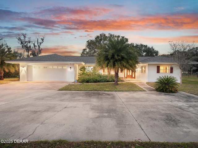 view of front of house featuring a garage and a yard