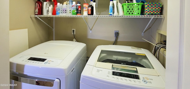 clothes washing area featuring washer and clothes dryer