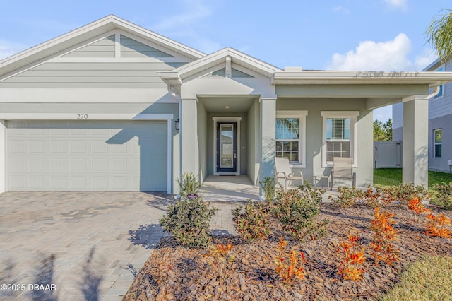 270 Eagle Harbor Way, Daytona Beach, FL 32124 - ranch-style home featuring an attached garage, a porch, stucco siding, and driveway
