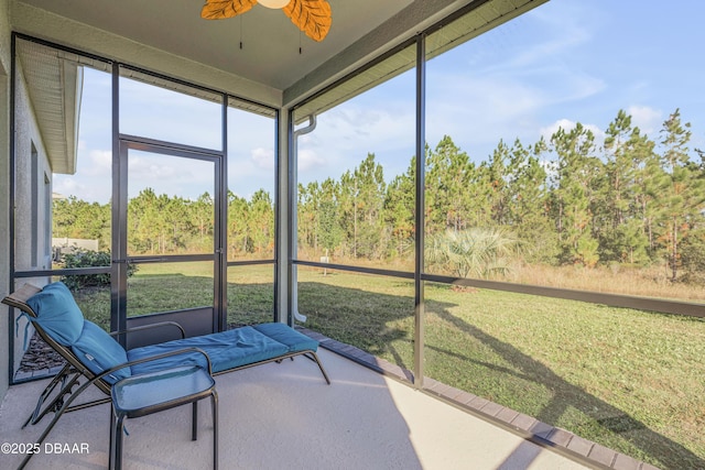 sunroom featuring ceiling fan