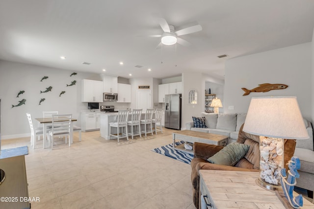 tiled living room featuring ceiling fan