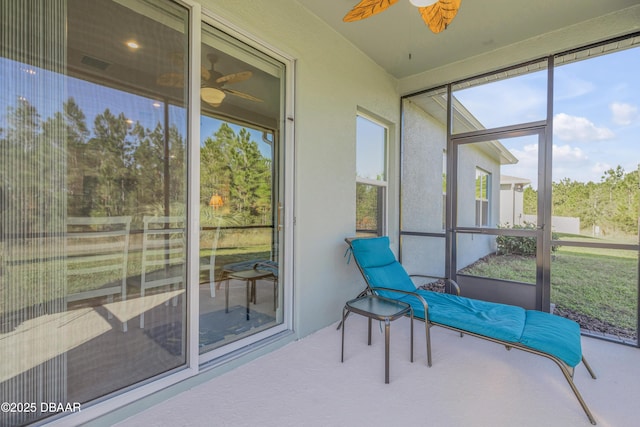 sunroom featuring ceiling fan and a wealth of natural light