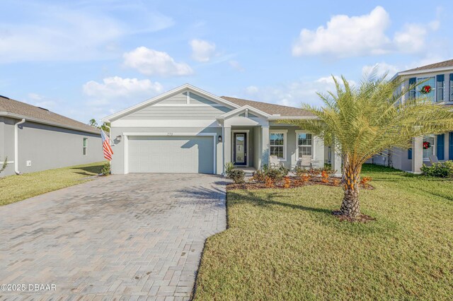 view of front facade with a garage and a front lawn