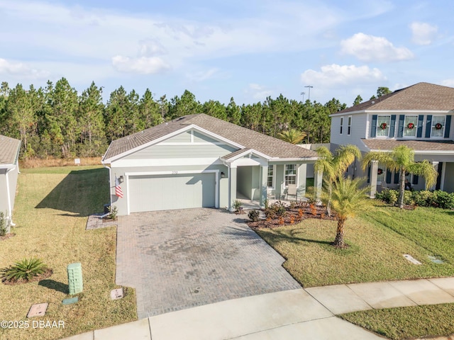 view of front of home featuring a front yard and a garage